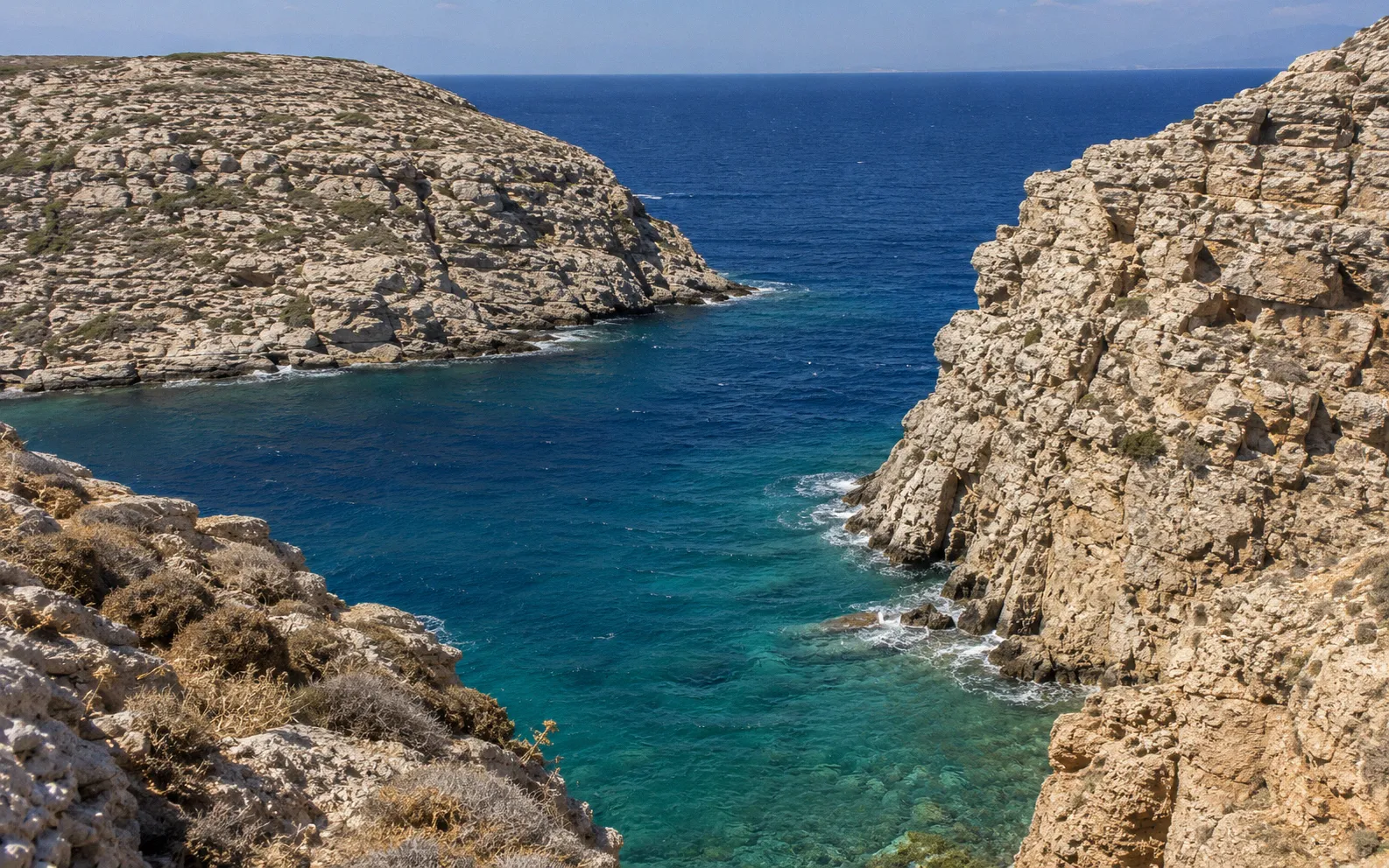 Rocky Mediterranean coastline with turquoise water between small Greek islands, the type of terrain feral Kri-kri goats swim across