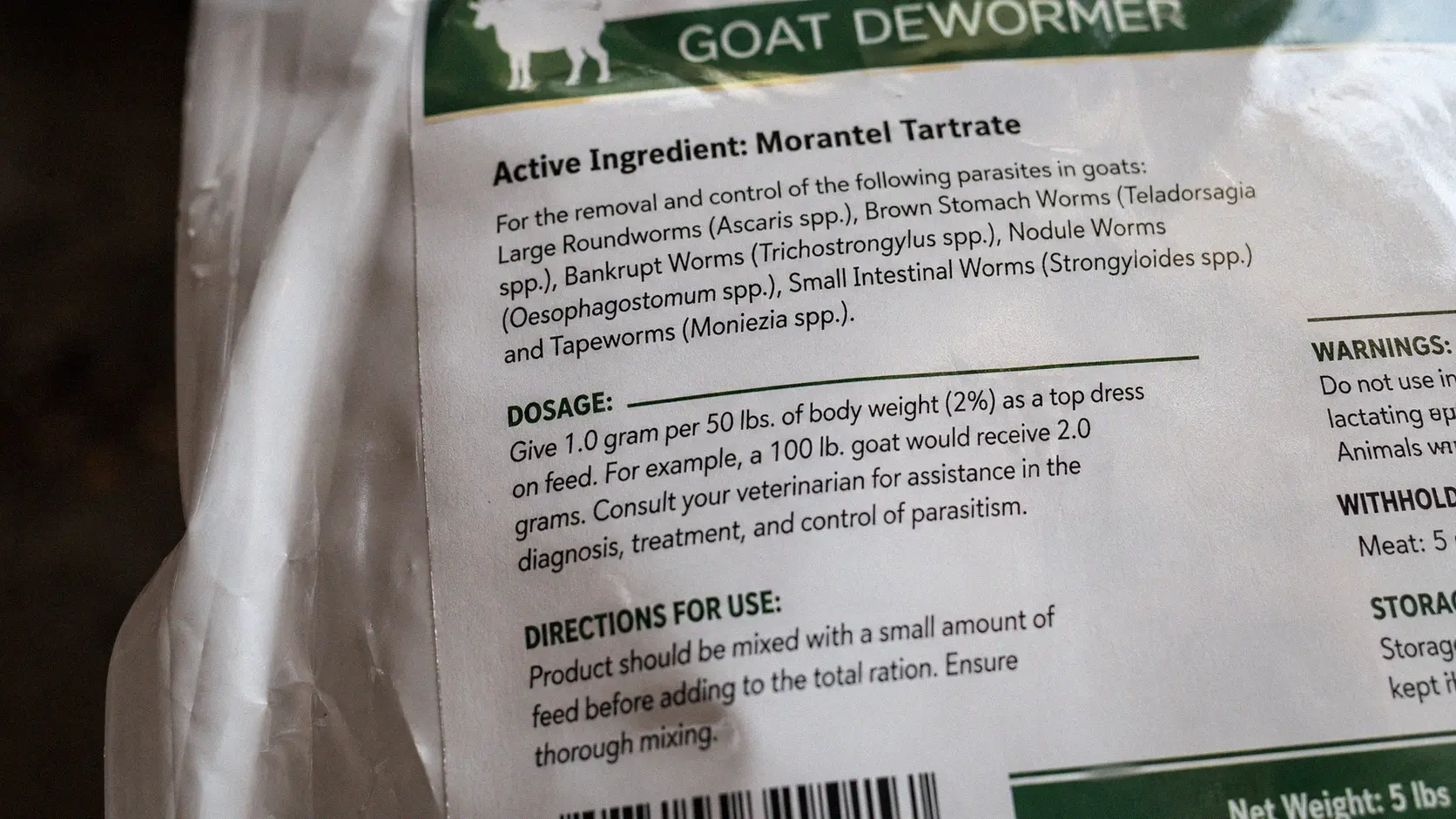Close-up of a dewormer product label showing active ingredient and dosage
